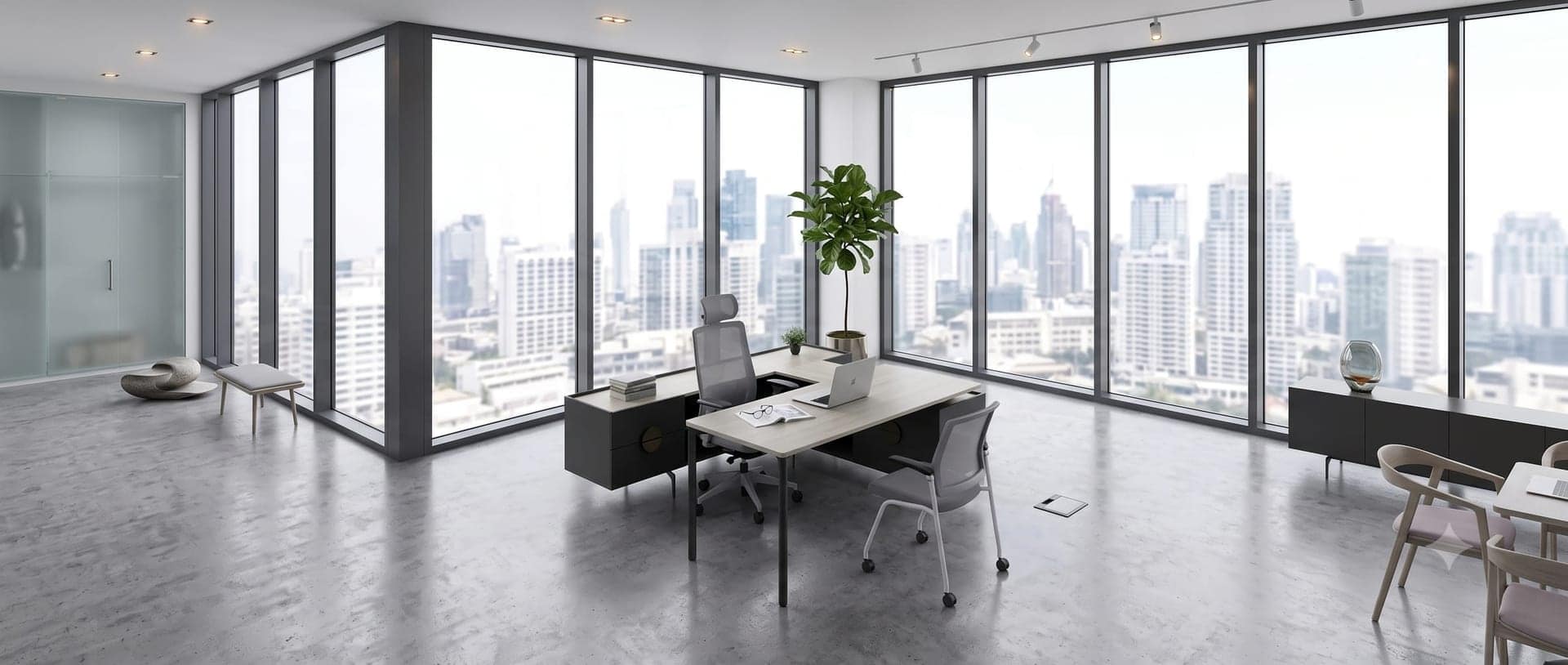 Executive office with desk, credenza and a meeting setting along the glazed wall